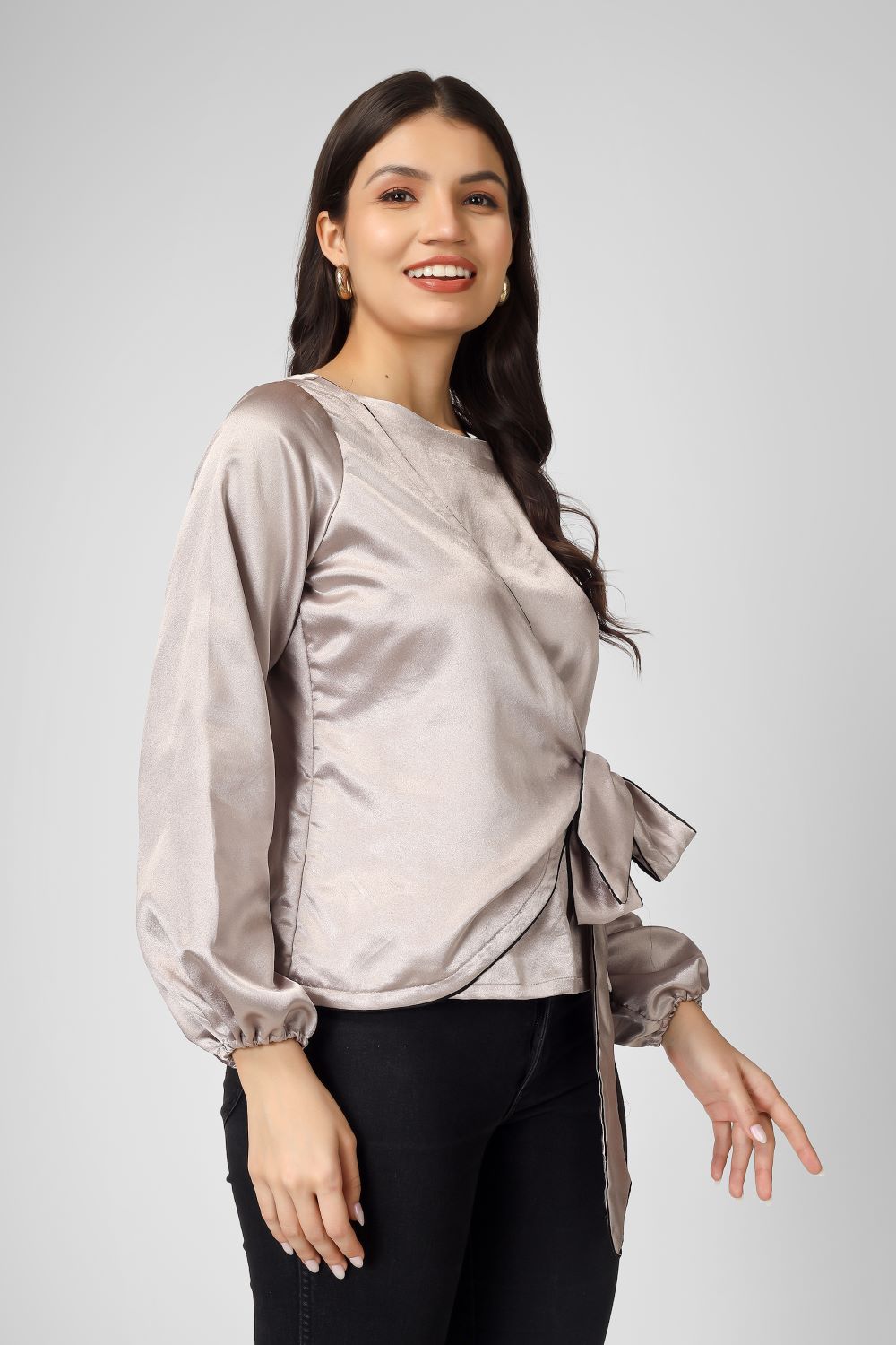 Elevate your look with this plain overlap satin top featuring full sleeves, a stylish tie knot, and neat piping detailing.