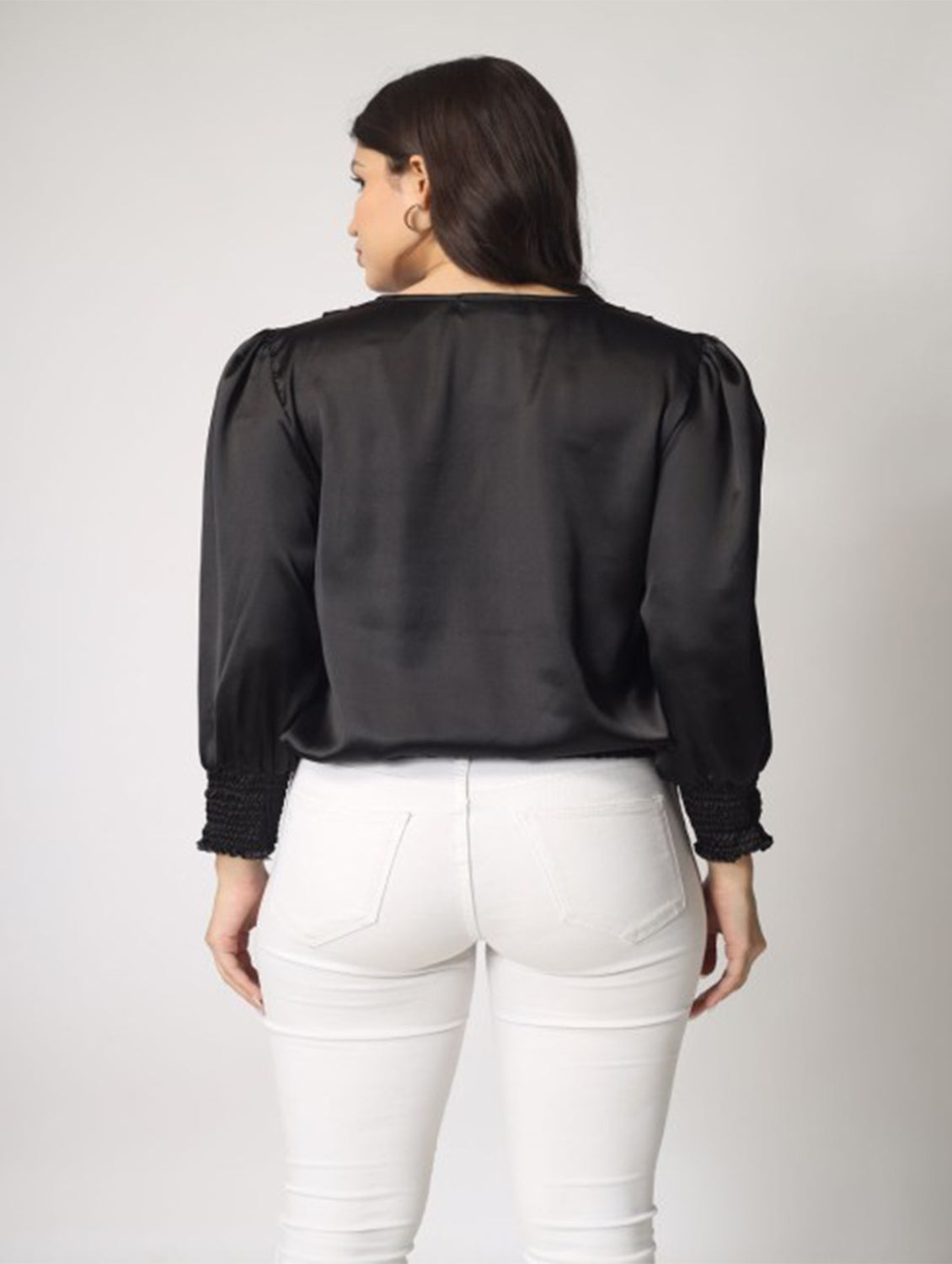 This solid black satin top with full sleeves and a stylish knot detailing at the hem is a perfect pick for party nights.