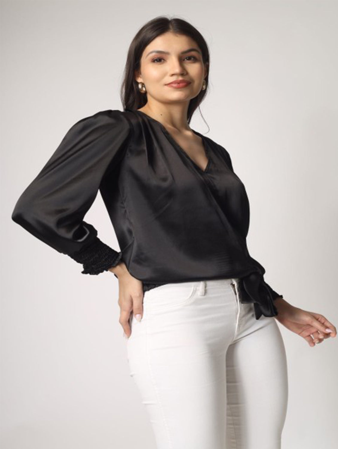 This solid black satin top with full sleeves and a stylish knot detailing at the hem is a perfect pick for party nights.