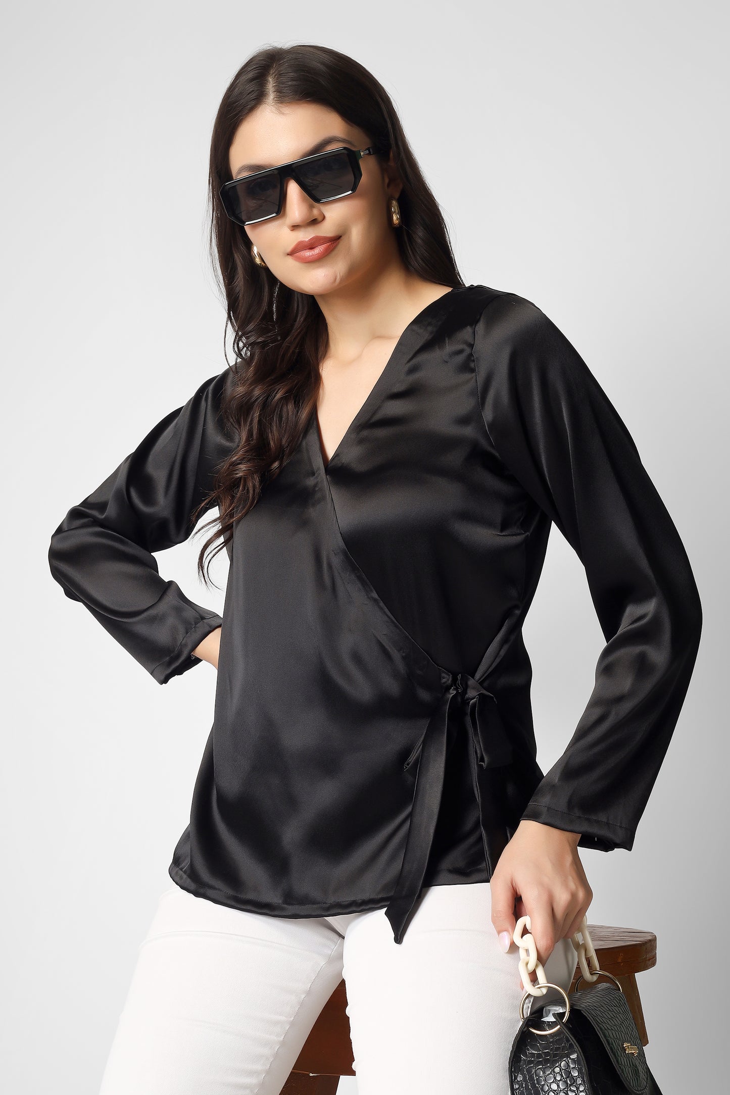 This plain black satin overlap top with full sleeves is the perfect mix of elegance and modern style.