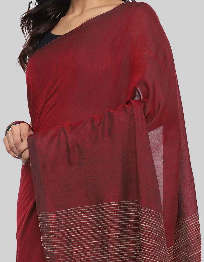 Maroon Linen saree with same blouse and strip and tessle on pallu is perfect workwear and party wear
