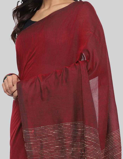 Maroon Linen saree with same blouse and strip and tessle on pallu is perfect workwear and party wear